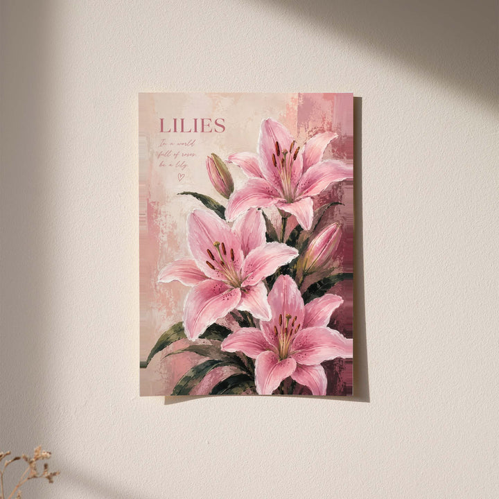 Pink lilies and buds with dark green leaves beneath a LILIES heading on a soft blush ground displayed without a visible frame on a softly lit pale wall