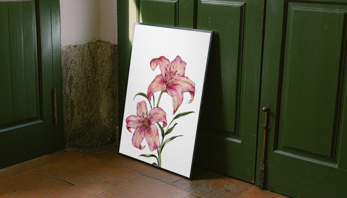 Two pink lilies with speckled petals and green leaves against white as an unframed print leaning against a green panelled door