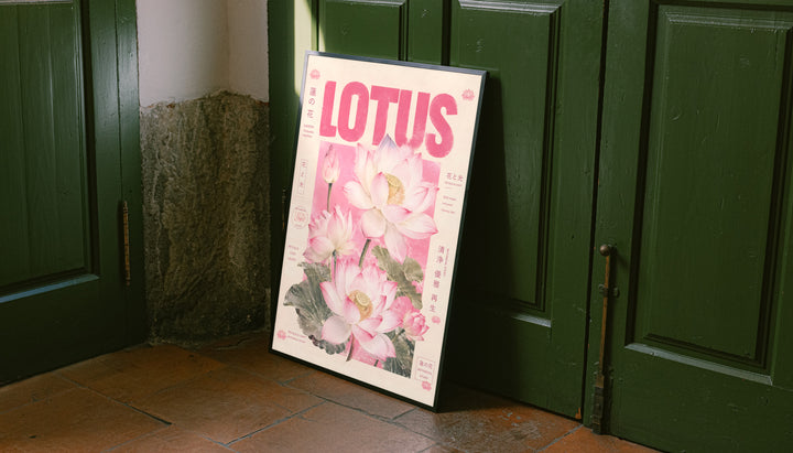 Pink lotus botanical poster leaning against green doors, bold LOTUS title with flowers