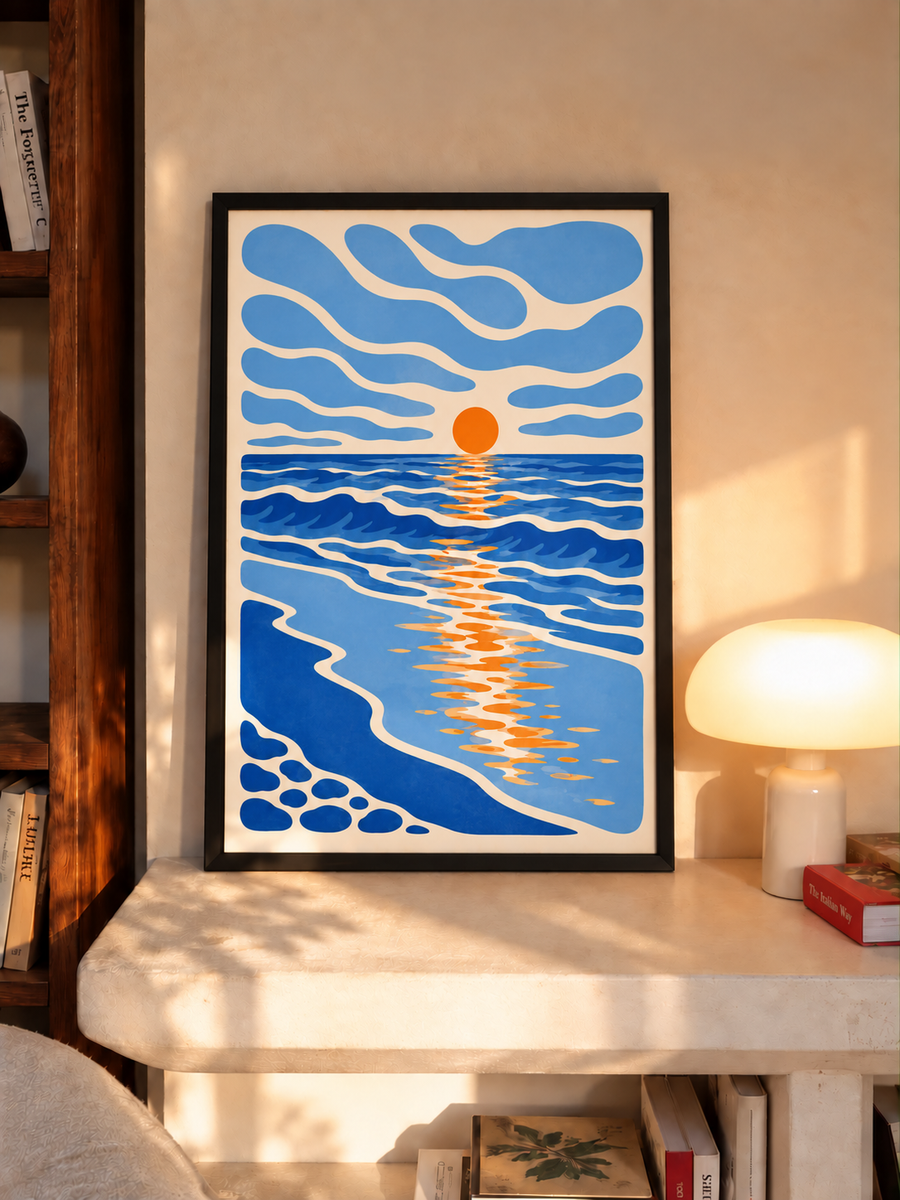 Framed coastal wall art print with blue waves and orange sun reflection, black frame