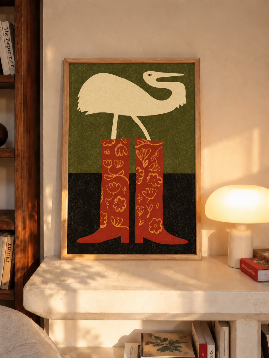 Framed crane and cowboy boots wall art on tabletop with cream bird and red patterned boots