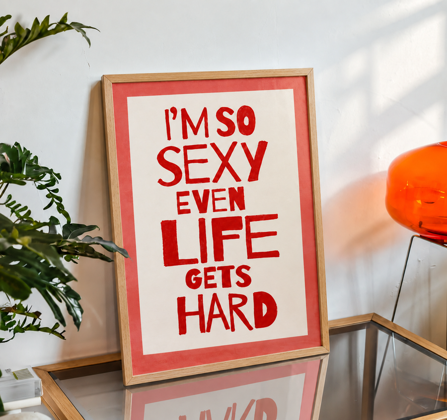 Wood-framed typography wall art with red quote 'I’M SO SEXY EVEN LIFE GETS HARD'