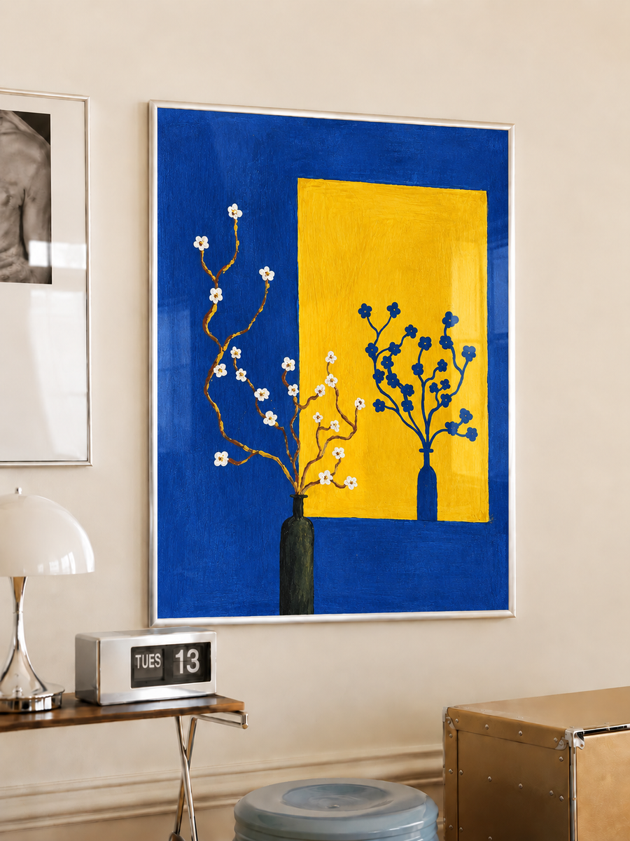 Framed floral still life wall art with yellow panel, blue blooms, and white blossoms in vase