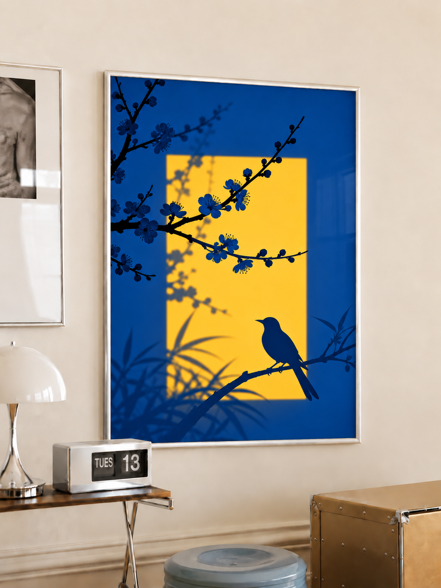Framed blue wall art with yellow center, bird silhouette on floral branch and flowers