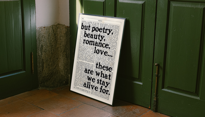 Poetry beauty romance love quote in black serif lettering over a cream two-column book page, styled in a black frame against dark green paneled doors above orange floor tiles