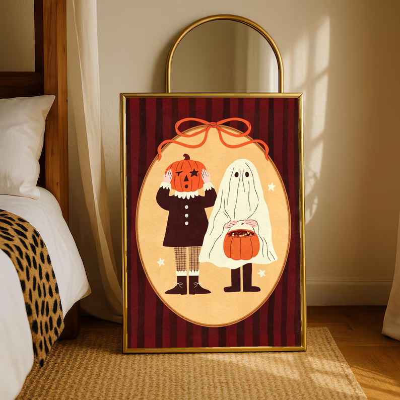 Gold-framed Halloween poster with pumpkin-head character and ghost on red striped oval artwork