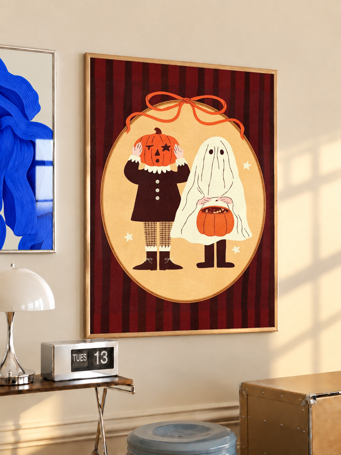 Framed Halloween poster featuring pumpkin-head figure and ghost on red striped oval design