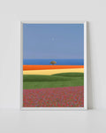White-framed landscape print: blue sky, ocean, green and red color bands