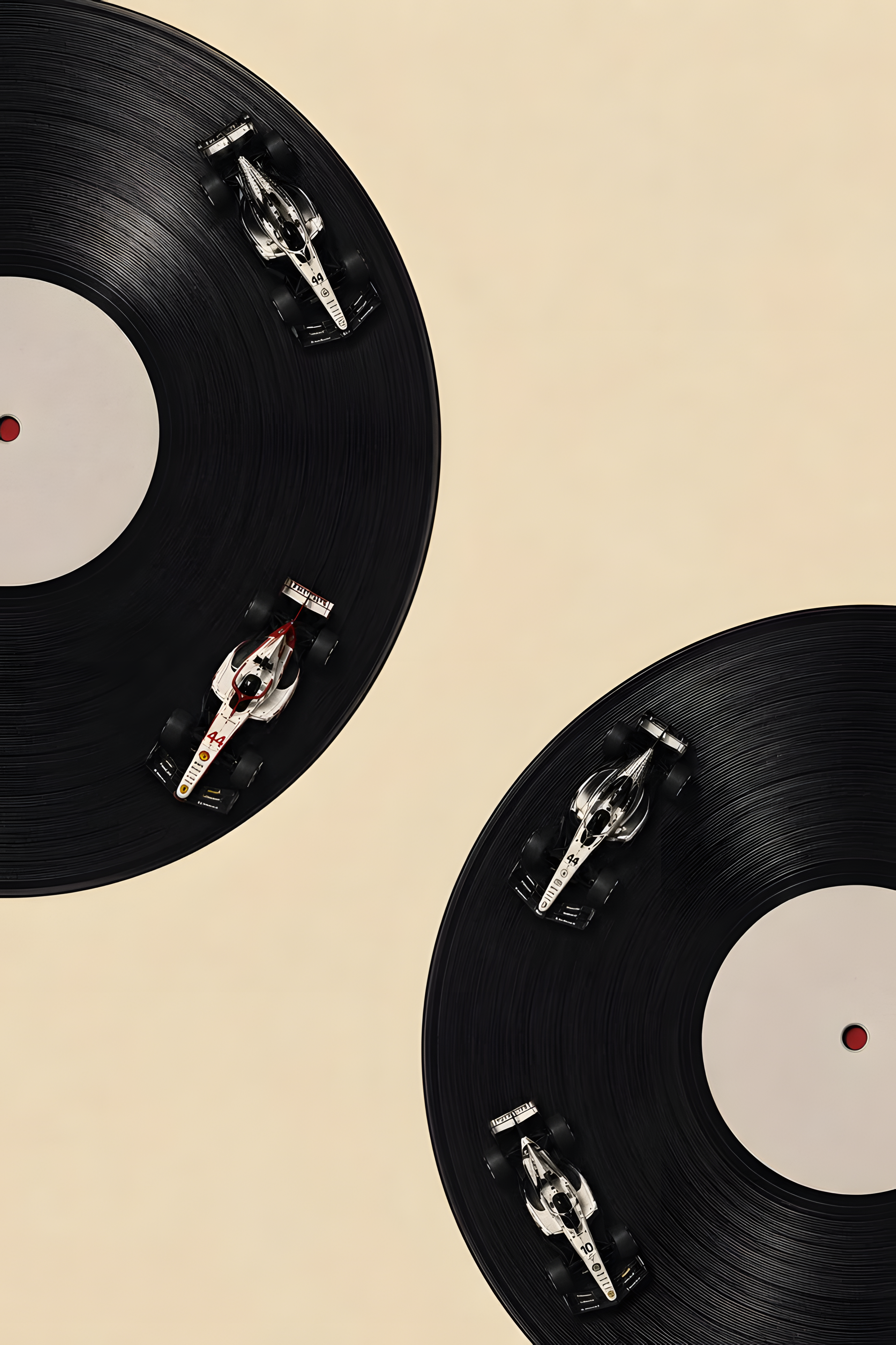 Vinyl record poster close-up: black disc graphics with small red dot details on cream