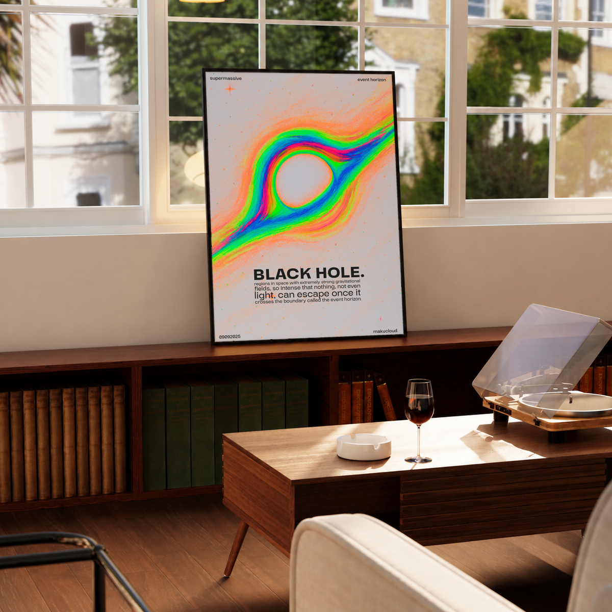 Rainbow Black Hole Poster in a black frame near a window and wooden table in a sunlit sitting room.