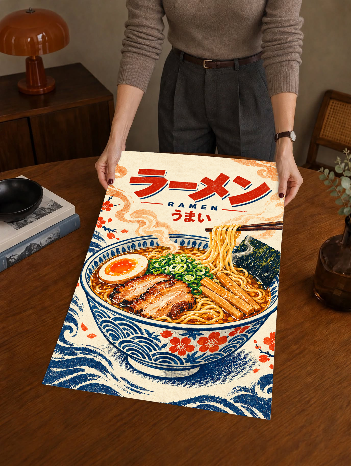 Ramen bowl poster held upright, showing chopsticks, egg, and Japanese lettering