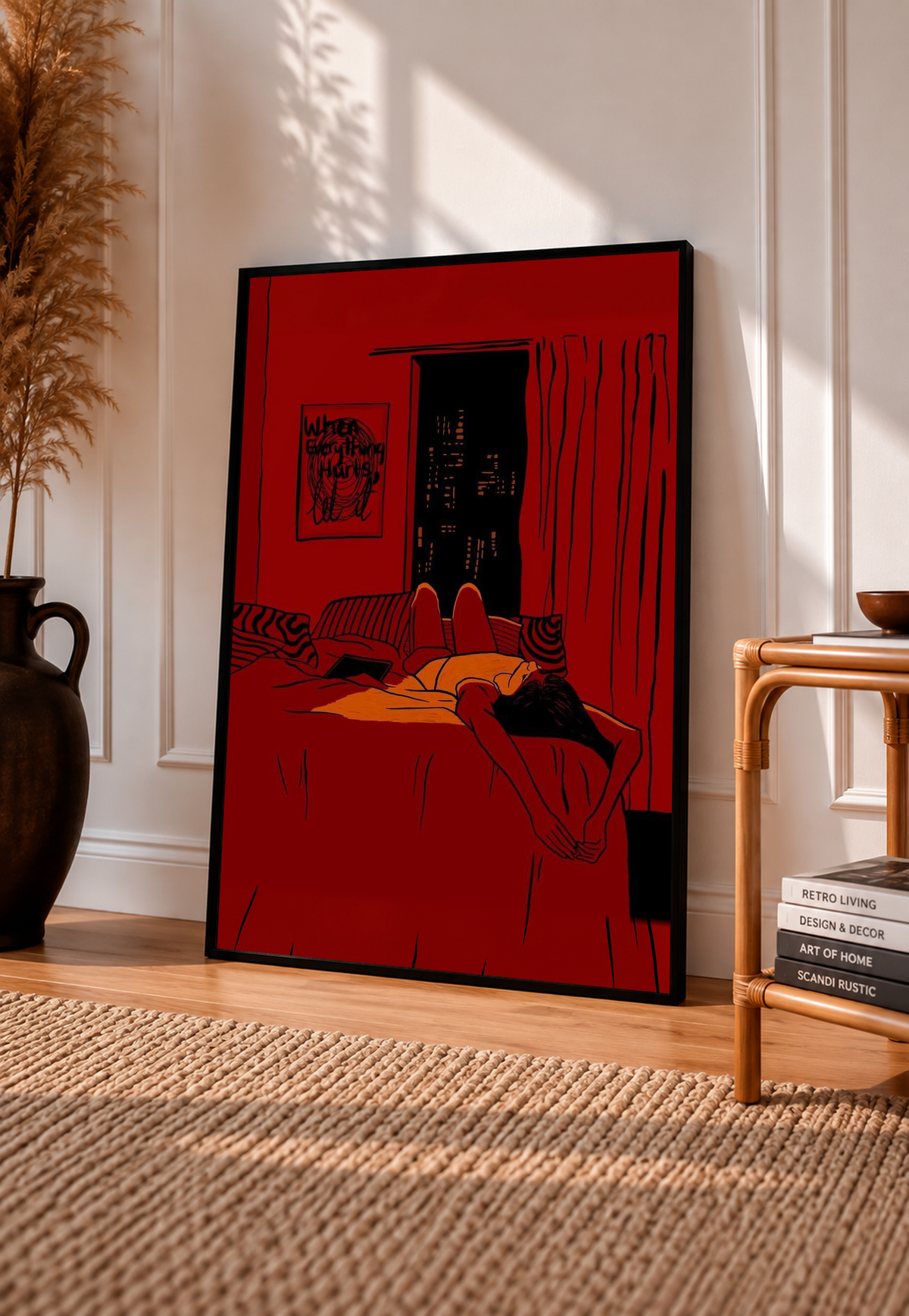 Red framed wall art print showing reclining woman on bed beside dark city window