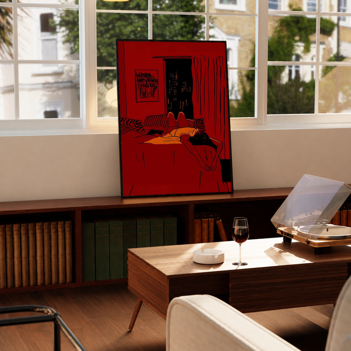 Red framed wall art print with reclining woman on bed and dark city skyline window