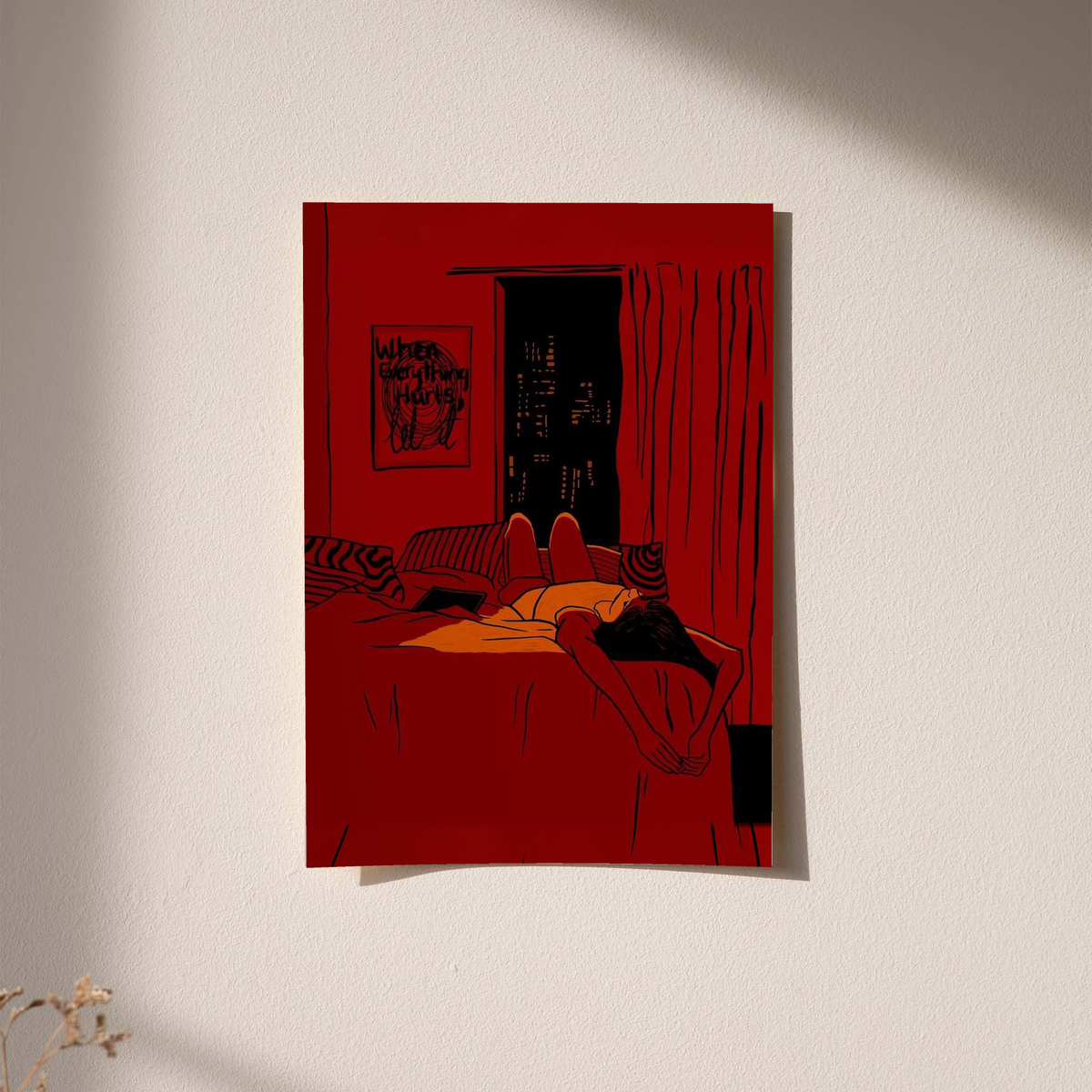 Red framed wall art print of reclining woman lying on bed with dark city window