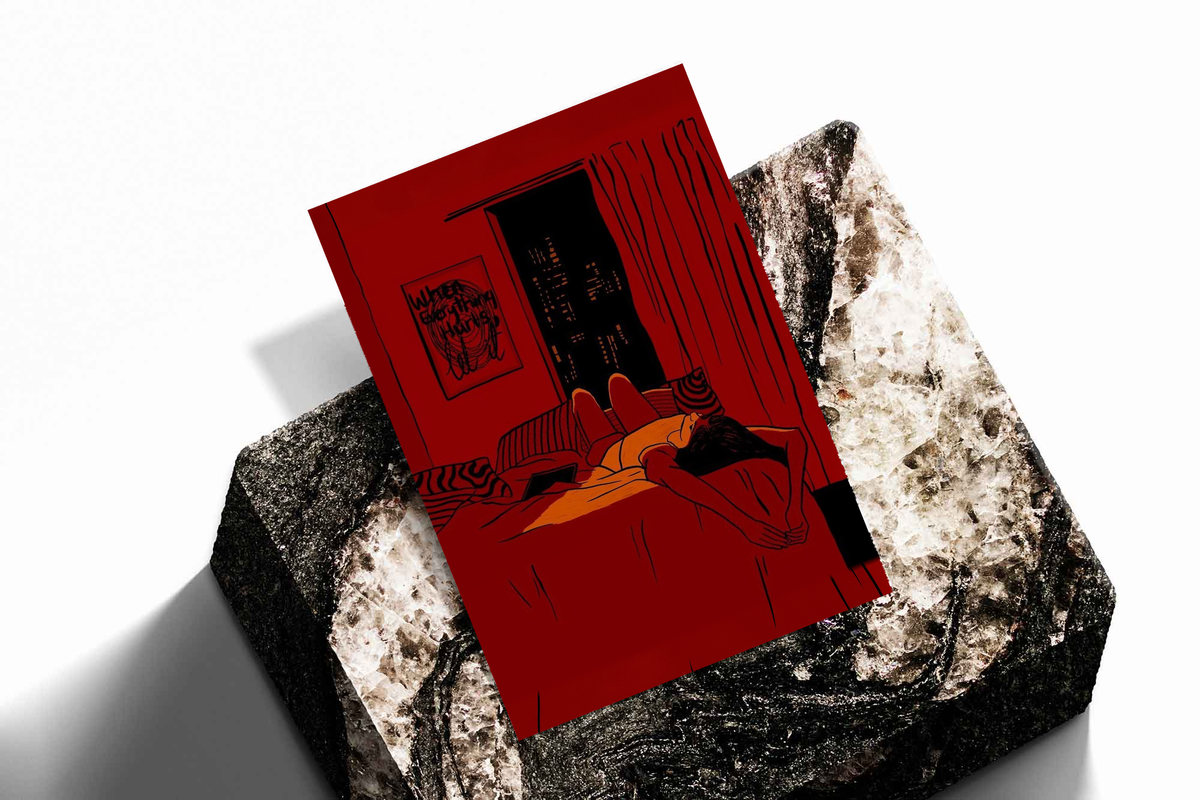 Red framed wall art print tilted on stone surface, reclining woman by dark city window