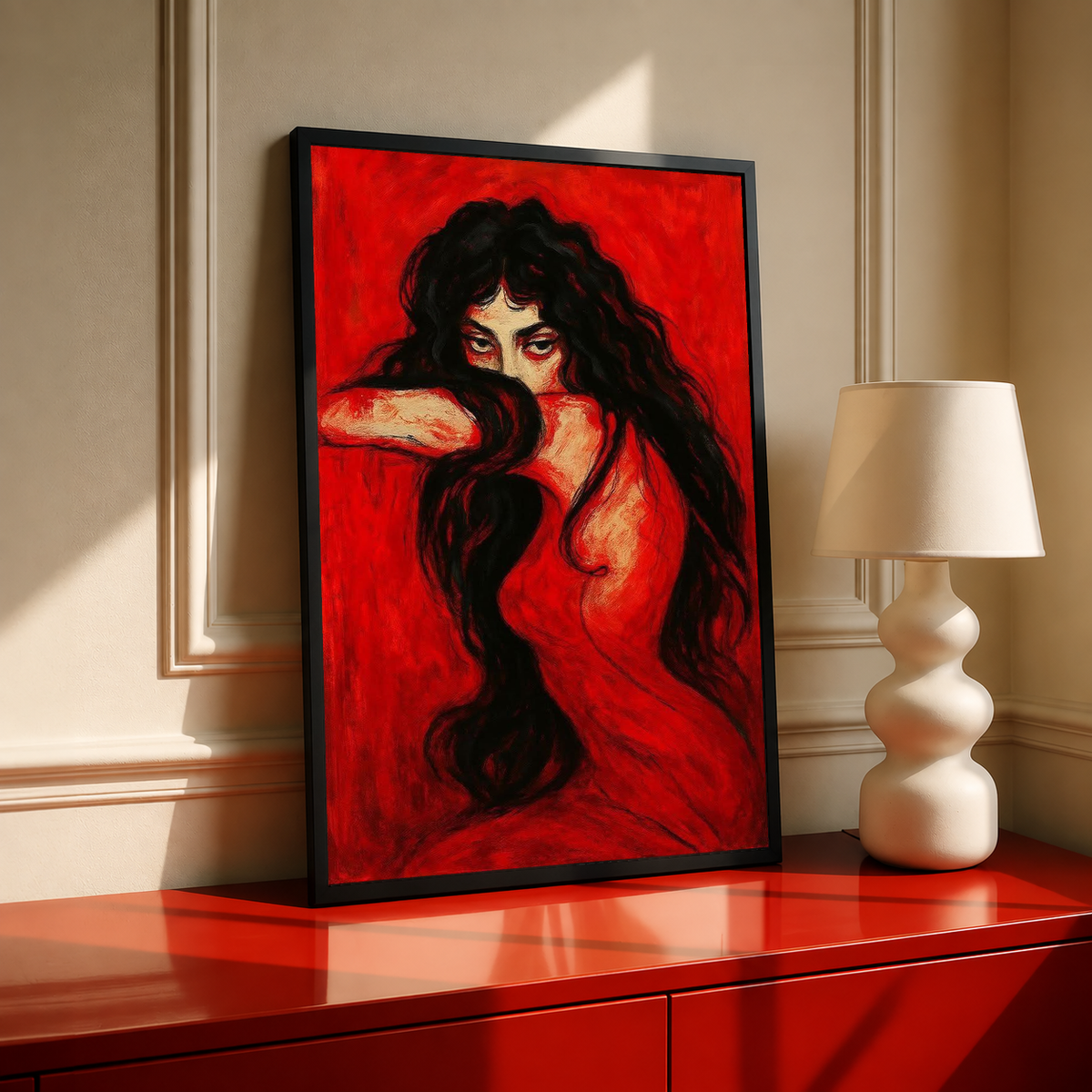 Framed portrait print of a long-haired woman on red, posed with hand near head
