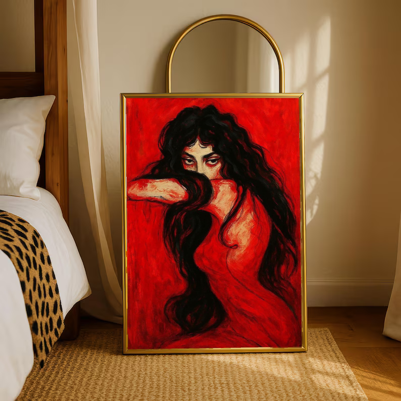 Framed portrait print of a long-haired woman on red, standing upright on a rug