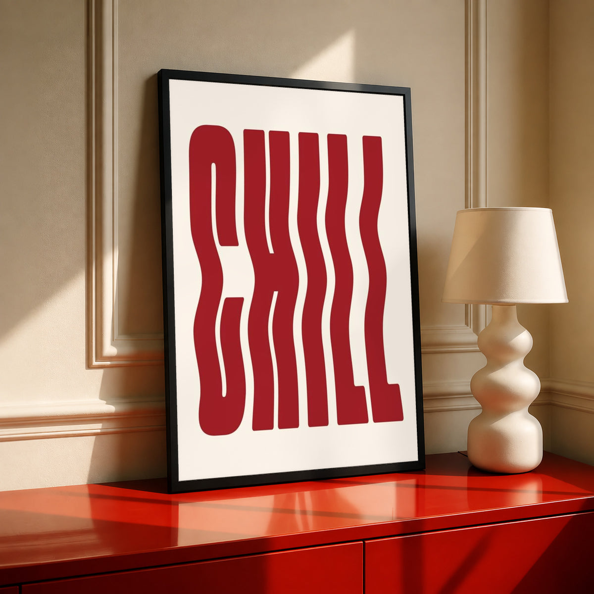 Framed typography poster with red wavy letters on cream, black frame