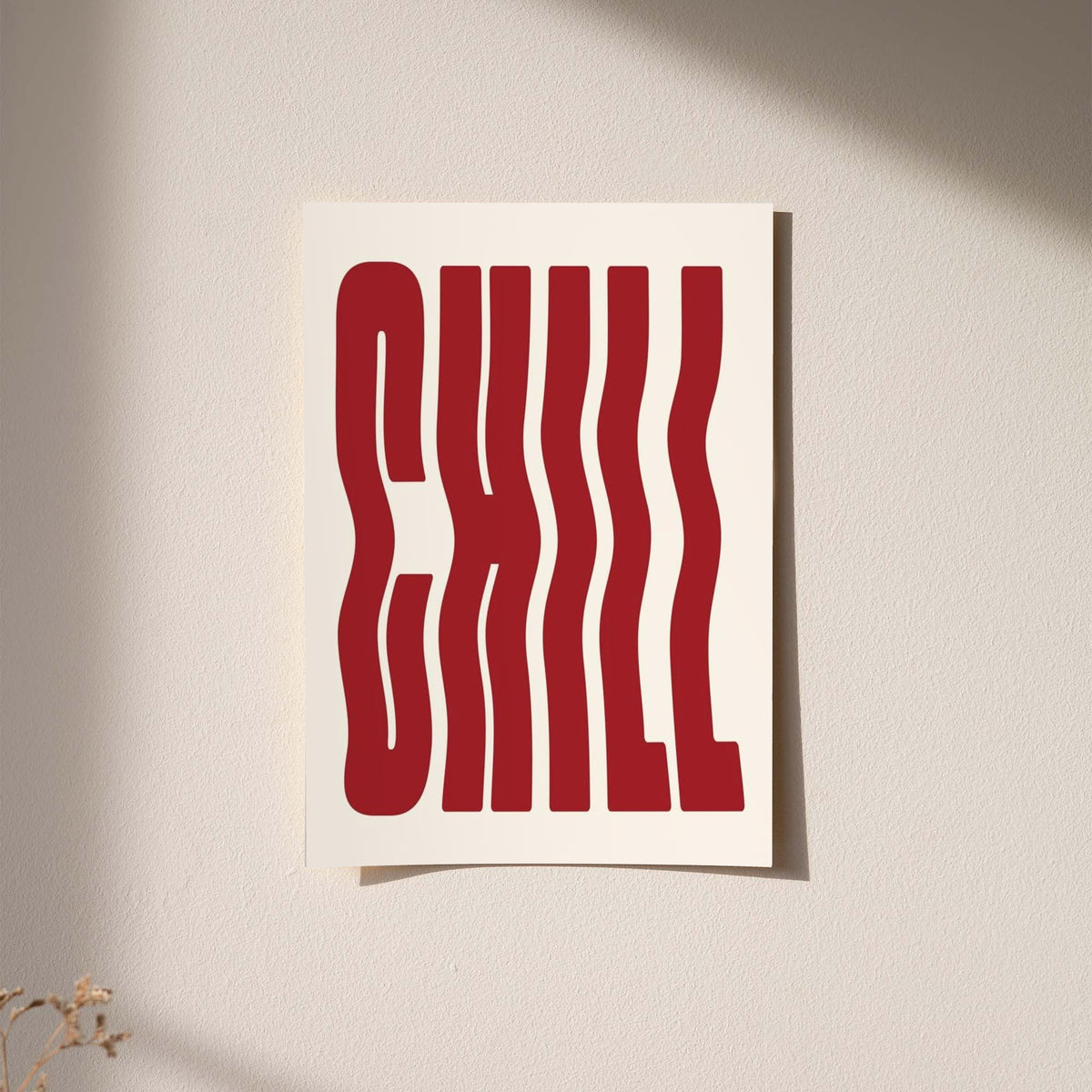 The word CHILL in tall wavy red lettering on a cream background displayed without a visible frame on a softly lit pale wall