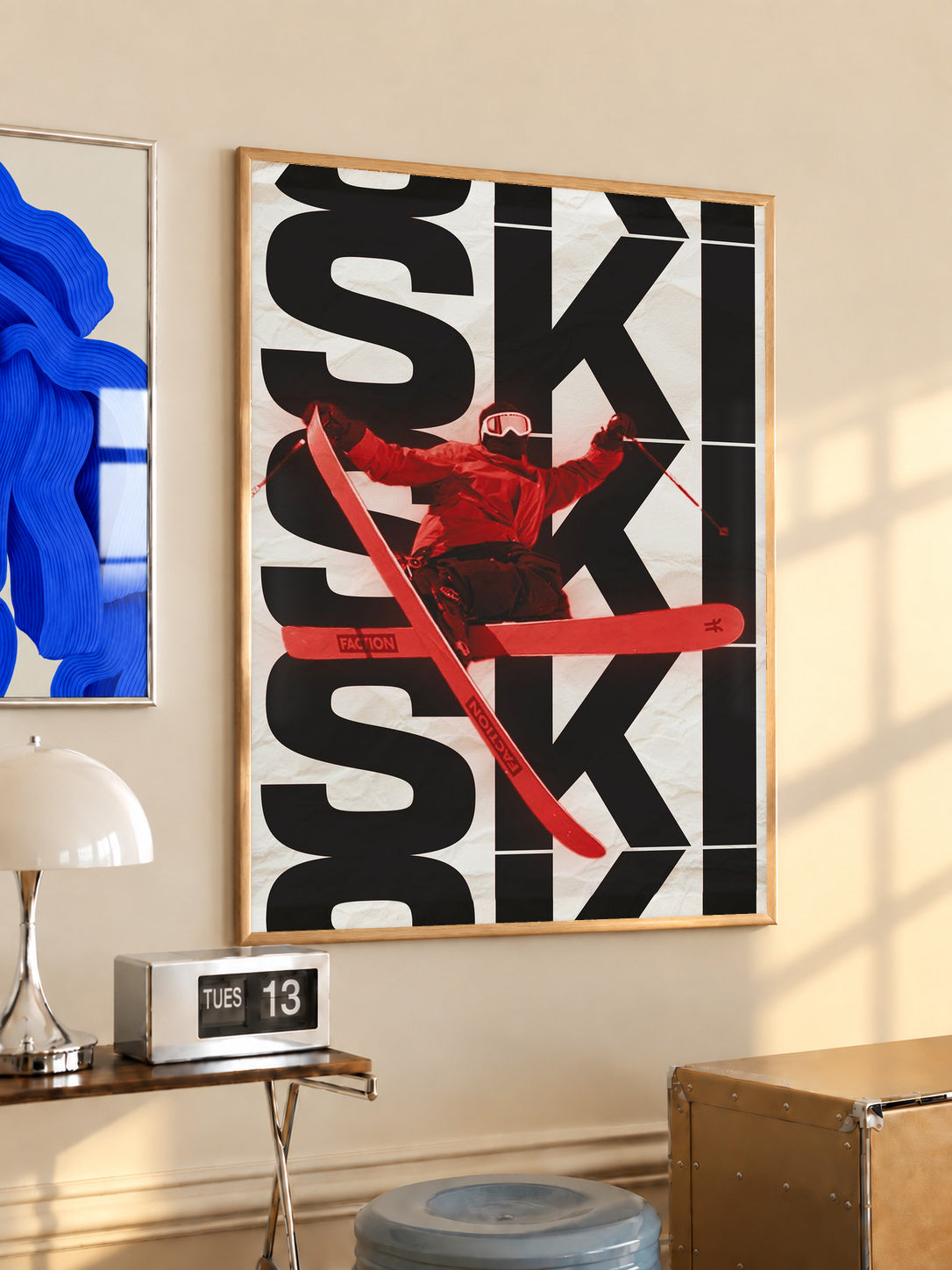 Framed ski poster with black SKI letters and red freestyler skiing across the design