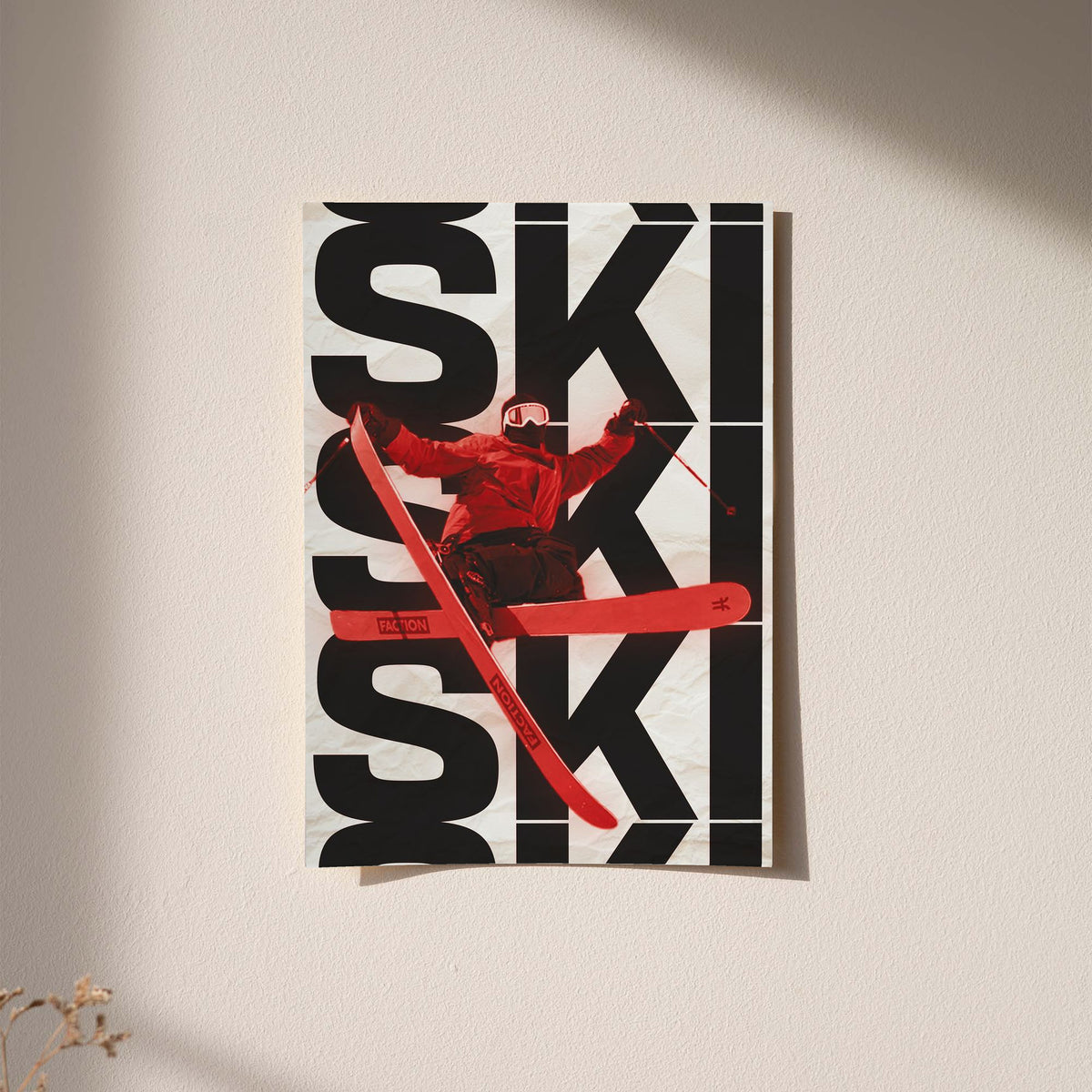 Wall-mounted framed ski poster with black SKI typography and red skier in motion