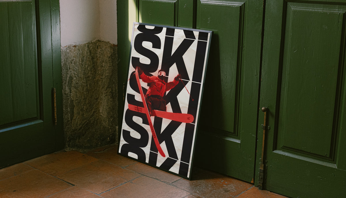 Framed ski poster with black SKI text, red skier figure, and diagonal ski graphic
