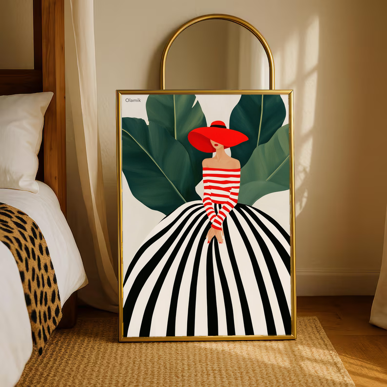 Framed woman portrait art print with red hat and striped dress, green leaves, gold frame.