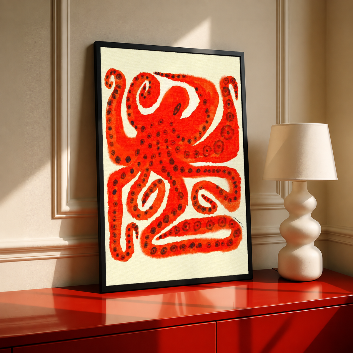 Black-framed octopus art print with red tentacles on cream paper, vertical