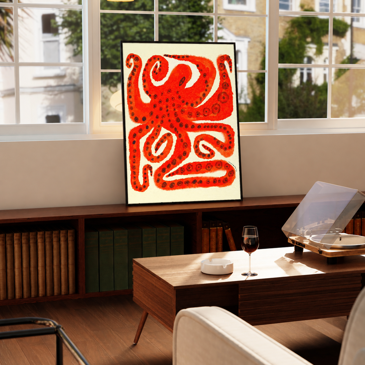 Black-framed octopus art print with red tentacles on cream paper