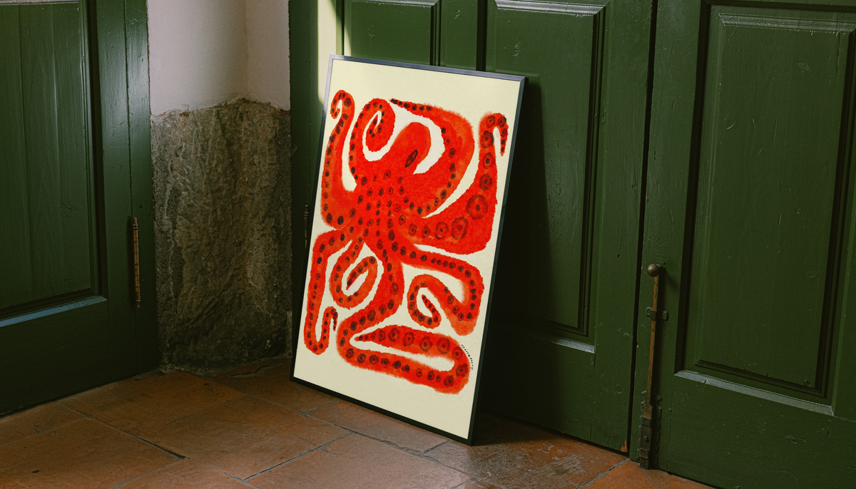 White-framed octopus art print with red curling tentacles on cream paper