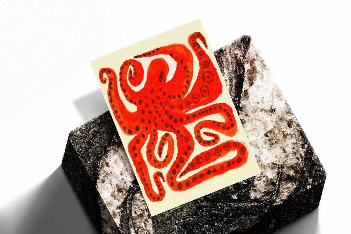 Unframed octopus art print with red curling tentacles on cream paper