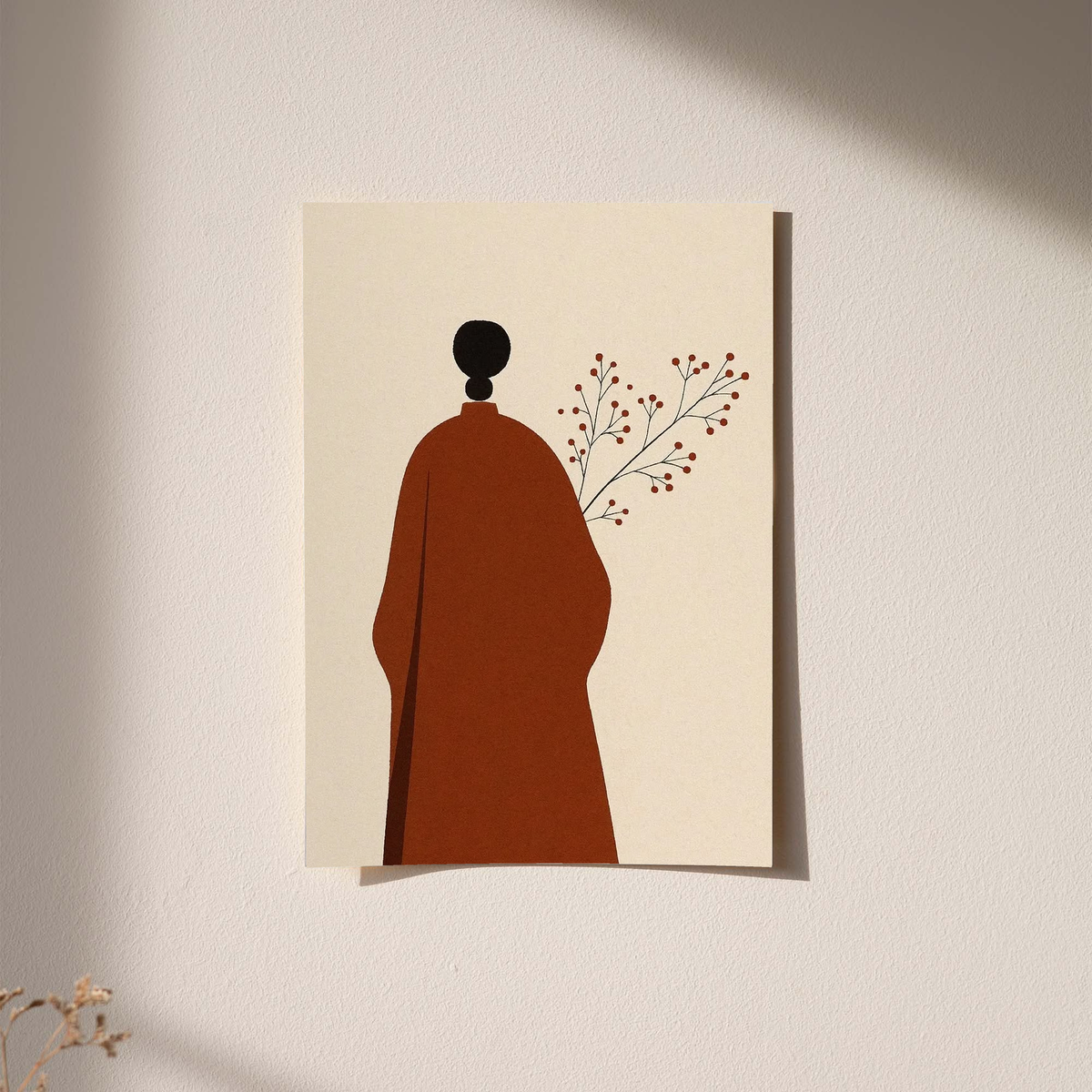 Cream art print with red robed figure silhouette, black head, and delicate branch