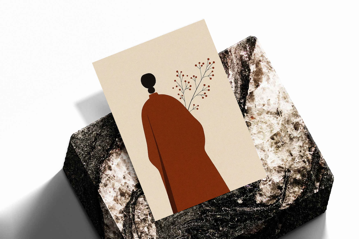 Stack of cream art prints showing red robed figure silhouette, black head, and delicate branch