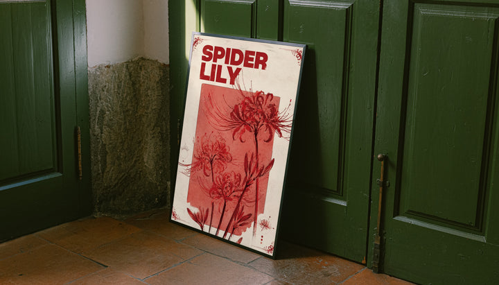 Red spider lily flowers and the words SPIDER LILY in a vintage cream and red botanical design leaning on the floor against dark green wall panelling