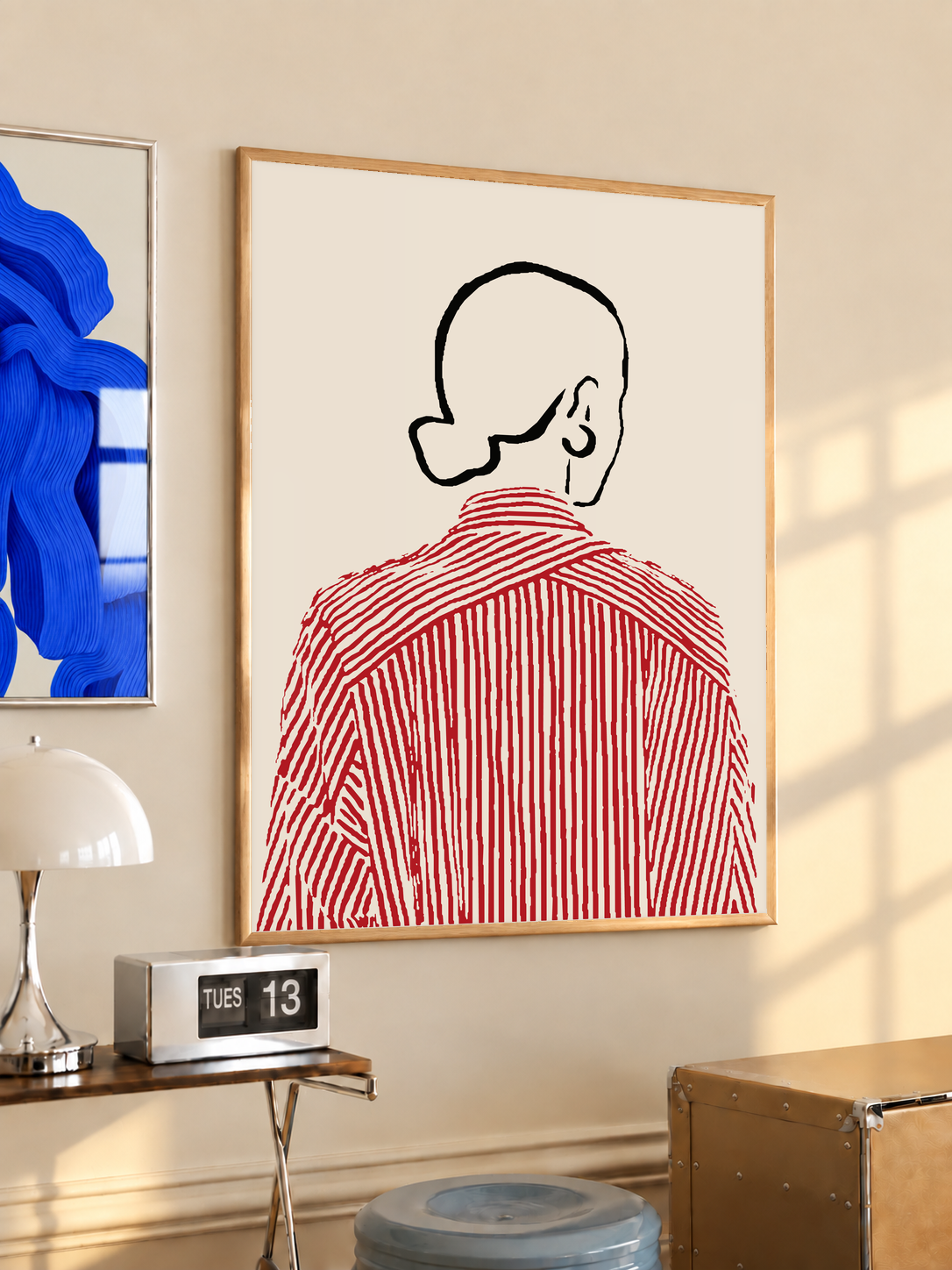 Wood-framed back-view shirt line art print with red striped shirt on cream