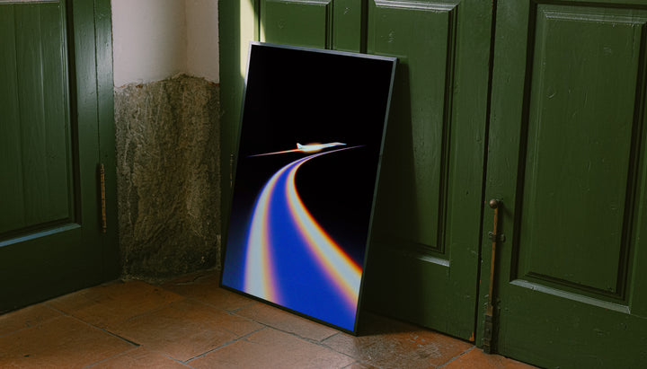 Jet poster with blue and orange flight trail on black, black frame