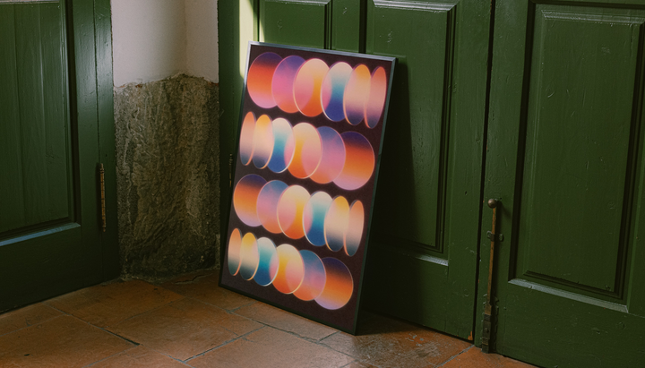 Retro Gradient Oval Poster shown as a canvas leaning beside green panels on a wooden floor.