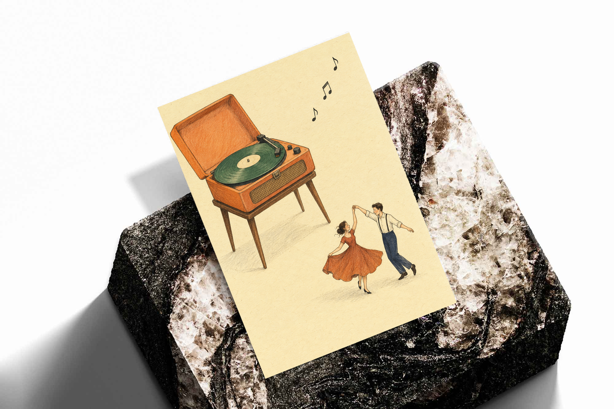Print featuring a retro record player and dancing couple with music notes, tilted on fabric