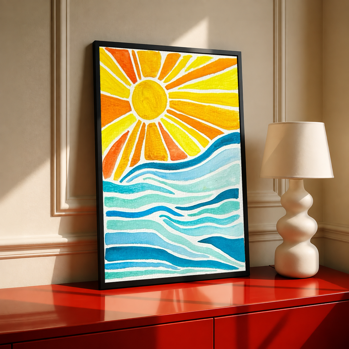 Sun rays over ocean waves in a black frame on a red cabinet beside a cream lamp