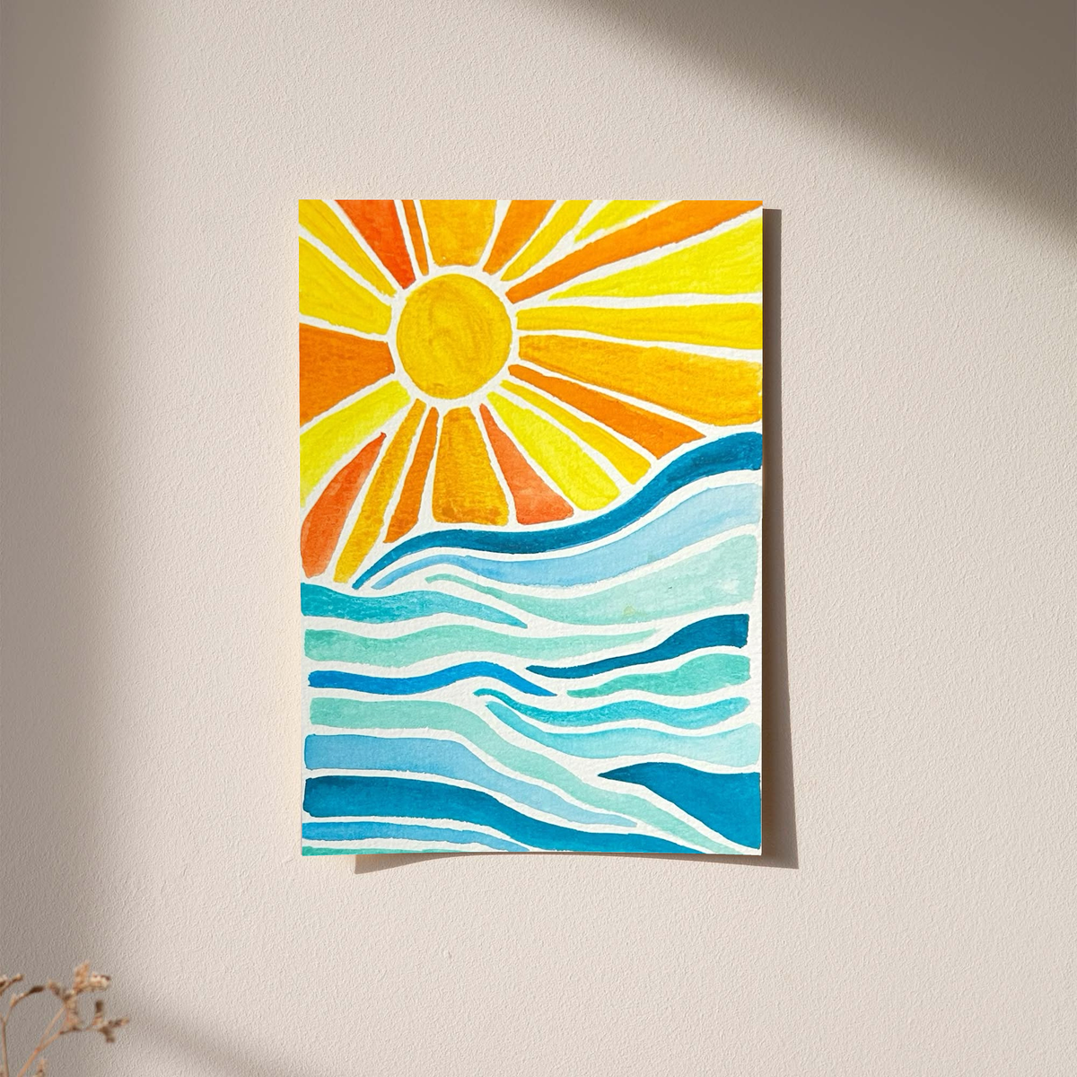 Sun rays over ocean waves as an unframed print against a pale plaster wall with soft shadows
