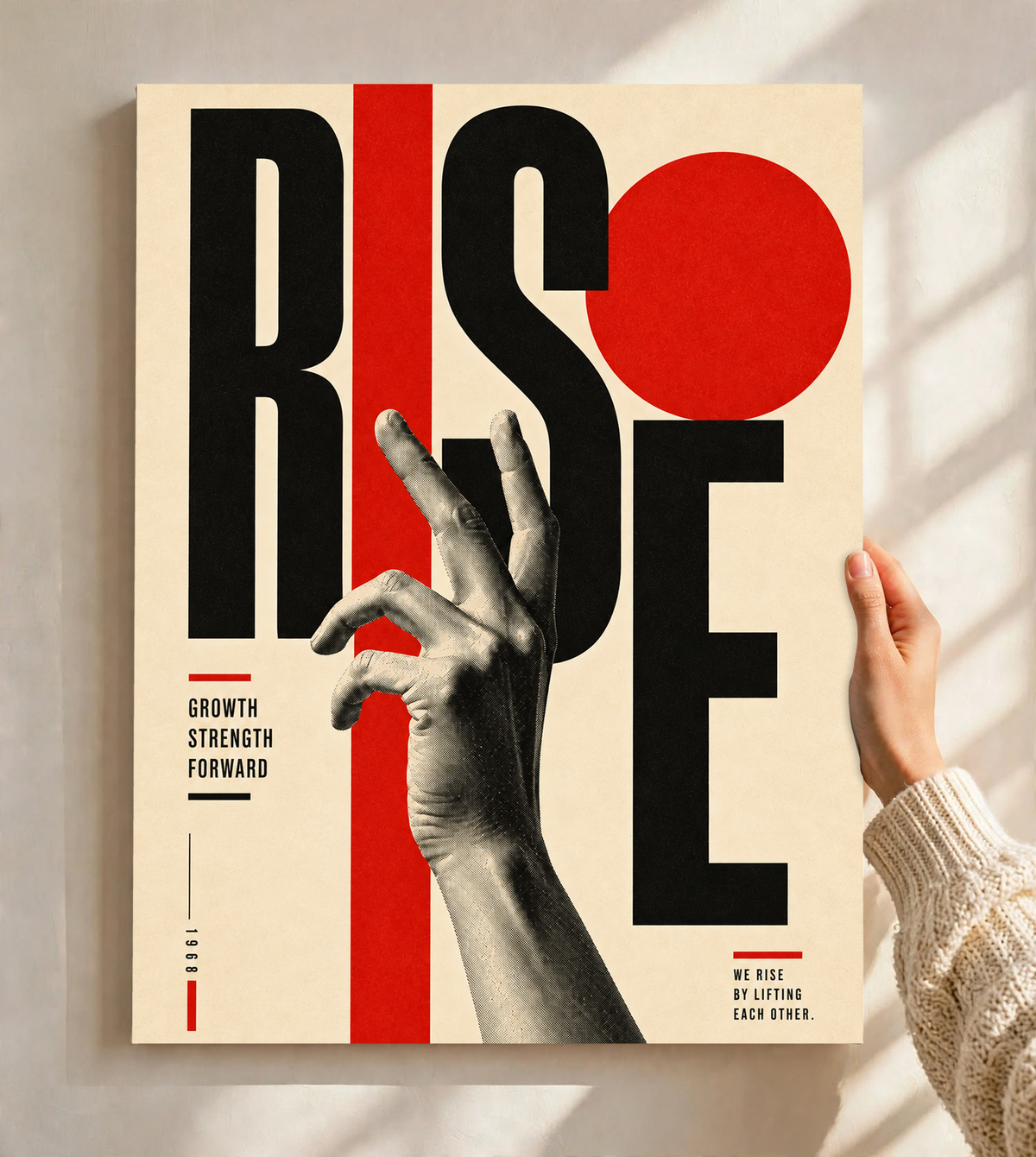 A reaching monochrome hand across oversized Rise lettering and red geometric shapes as an unframed poster held against a pale sunlit wall