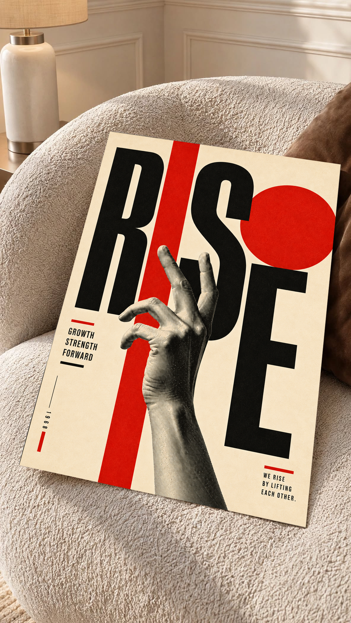 A reaching monochrome hand across oversized Rise lettering and red geometric shapes as an unframed poster resting on a cream woven chair