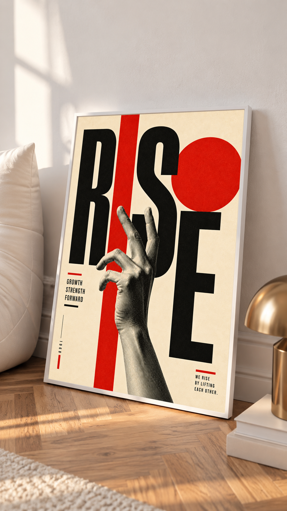 A reaching monochrome hand across oversized Rise lettering and red geometric shapes in a white frame on a sunlit floor beside a white cabinet