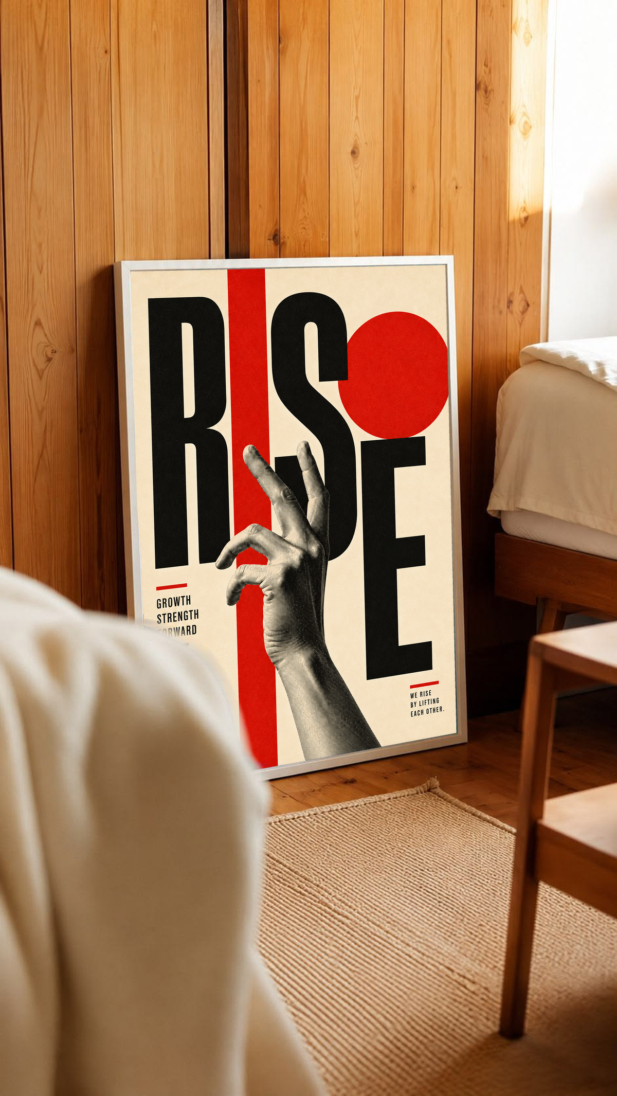A reaching monochrome hand across oversized Rise lettering and red geometric shapes in a white frame leaning against warm wooden wall panels
