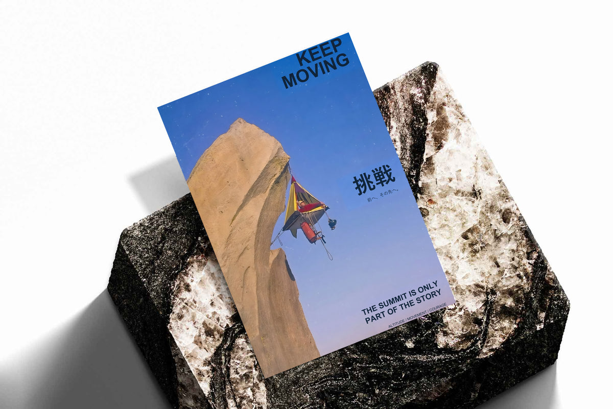 Motivational poster lying on textured rocks, blue cliff scene with rock climber