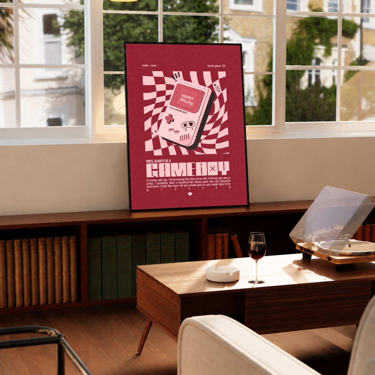 A pink Game Boy-style console with Heart Break screen on a wavy pink checkerboard in a black frame by a bright window above a record player