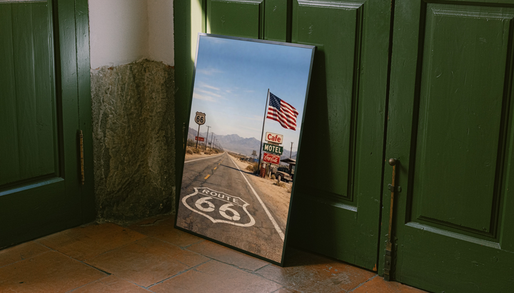Route 66 Desert Road Poster shown as a canvas leaning beside green panels on a wooden floor.
