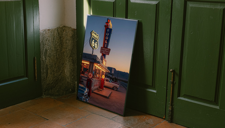 Route 66 Diner Poster shown as a canvas leaning beside green panels on a wooden floor.