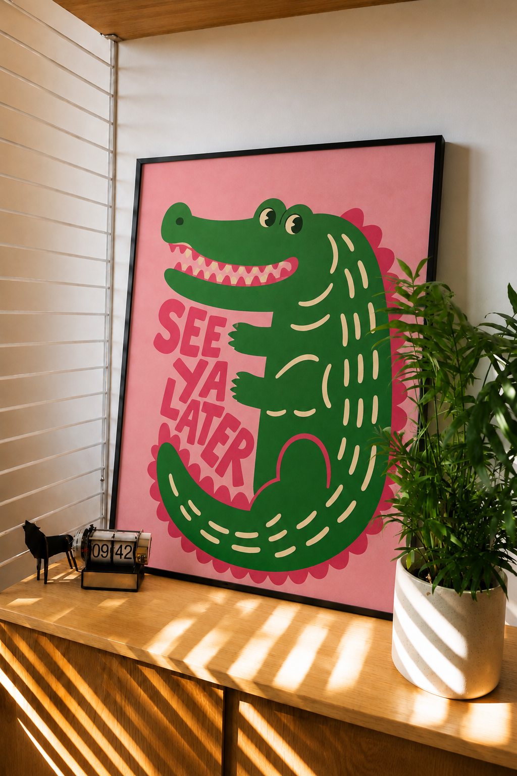 Framed wall art with green alligator, 'SEE YA LATER' text on pink background
