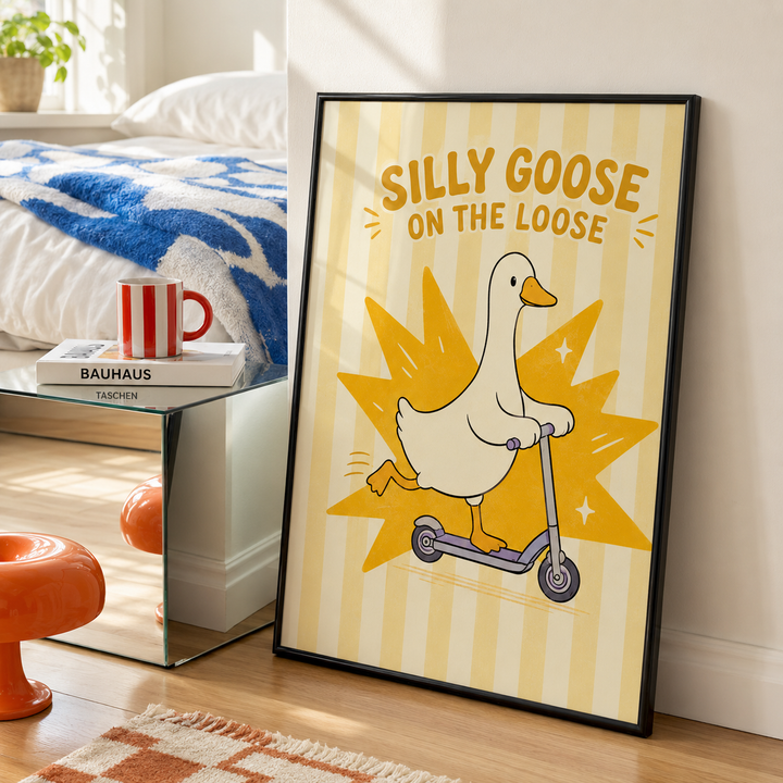 Black-framed poster wall art with white goose on scooter and yellow starburst rays